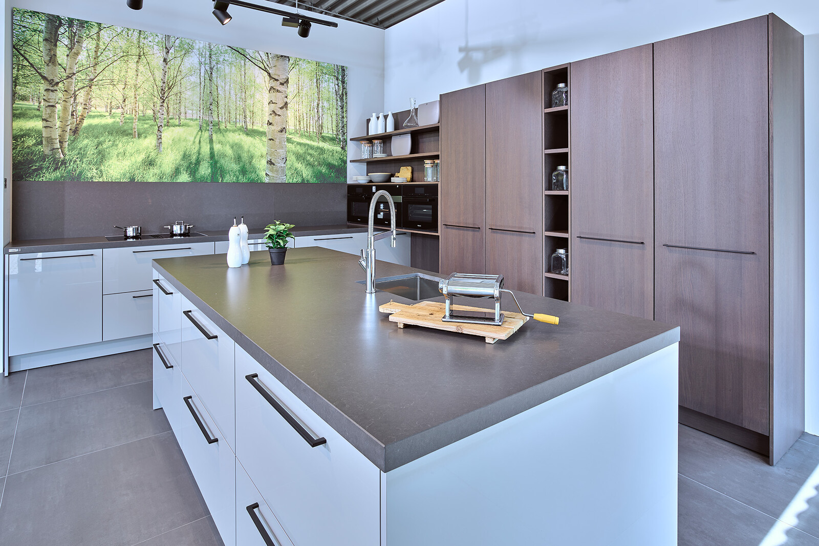 Showroomkeuken: SieMatic designkeuken in lichtgrijs met keukeneiland en eikenhouten kastenwand