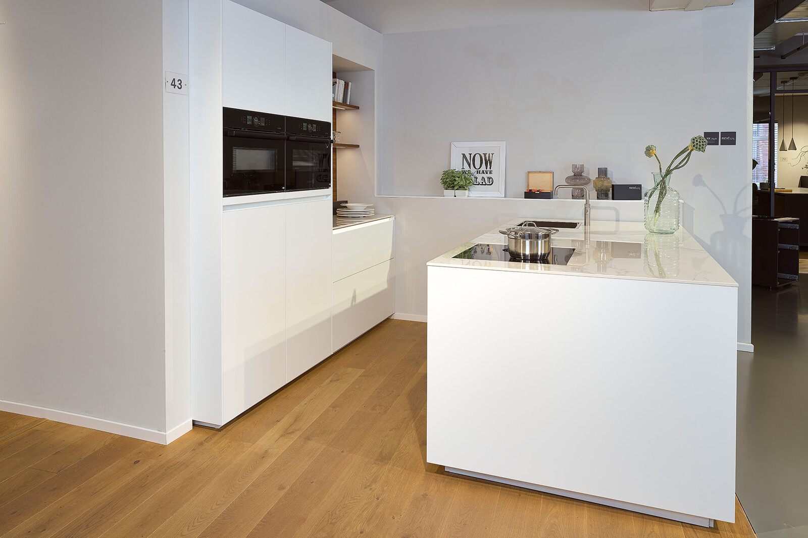 Showroomkeuken next125 - Witte eilandkeuken in fenix met notenhout met keramiek keukenblad