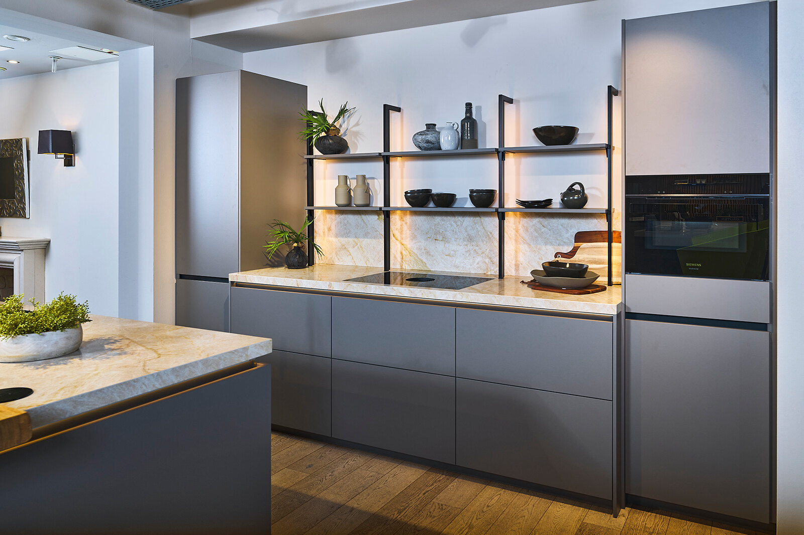 Showroomkeuken Ballerina: taupe eilandkeuken met kooknis en industrieel rek -  Ekelhoff