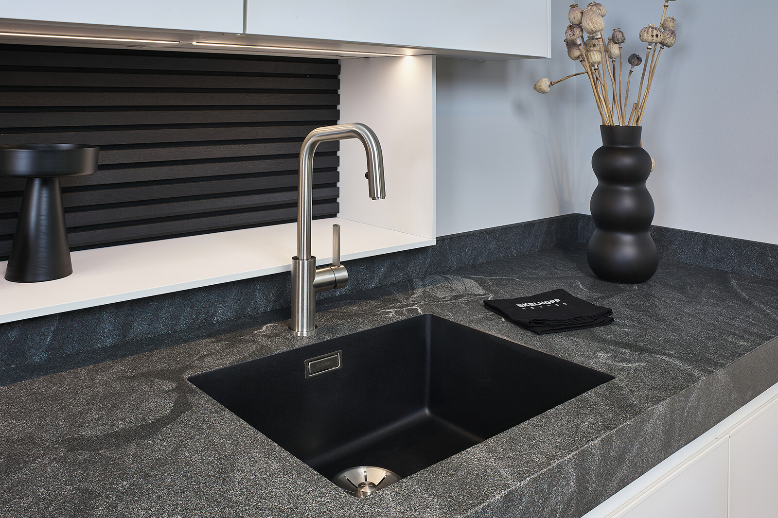 Showroomkeuken: SieMatic Mondial met schiereiland in lotuswit met 8 cm granieten keukenblad