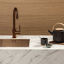 Helle Topcore Laminat Arbeitsplatte mit kupferner Spüle und Wasserhahn. Auch bei Ekelhoff Küchen in Nordhorn