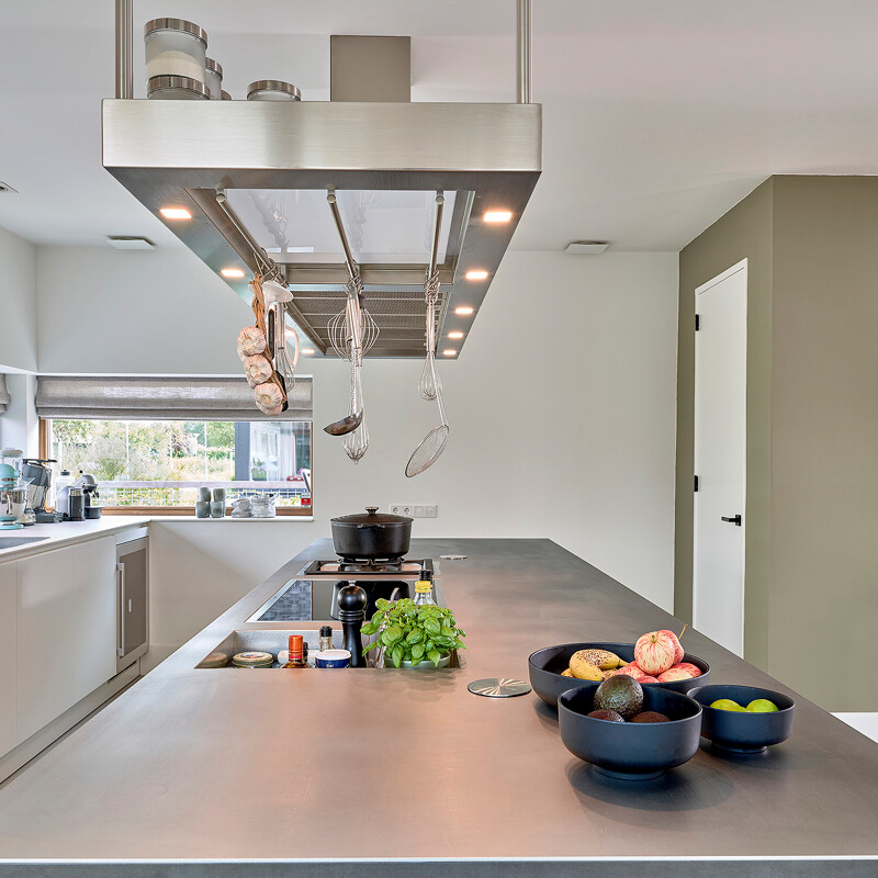 Küche im industriellen Stil mit industrieller Kücheninsel. Die Küchenschränke sind von Contur, die Arbeitsplatte ist aus Edelstahl, die Geräte von Gaggenau.