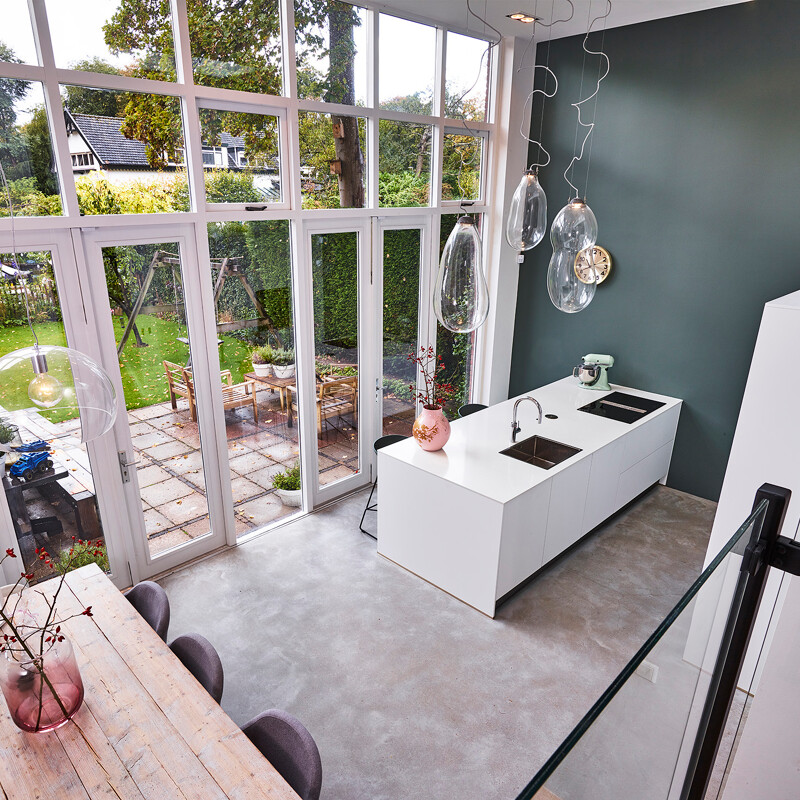 Schlichte grifflose Inselküche in Mattweiß mit weißer Arbeitsplatte in Marmoroptik von Ekelhoff Küchen