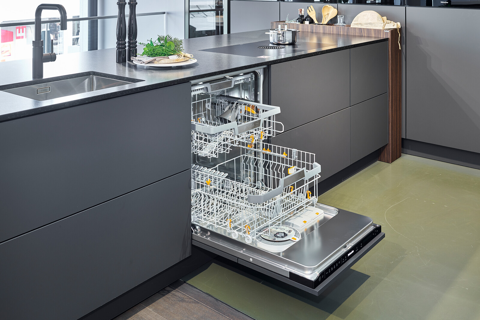 SieMatic Showroomkeuken in grafietgrijs met vitrinekasten en Miele vaatwasser
